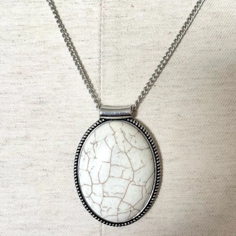 White pendant necklace on silver tone chain
